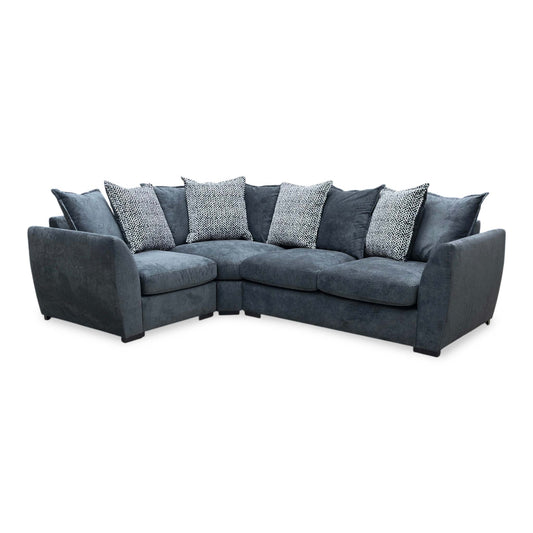Full view shot of the Havana left-hand corner sofa, upholstered in a premium charcoal grey fabric, featuring a generous chaise lounging section, plush seating, and modern block feet.