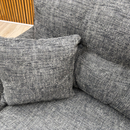 High-definition close-up shot of the charcoal fabric upholstery, highlighting its fine, durable weave pattern, rich dark grey tone, and high-quality tailored seams.