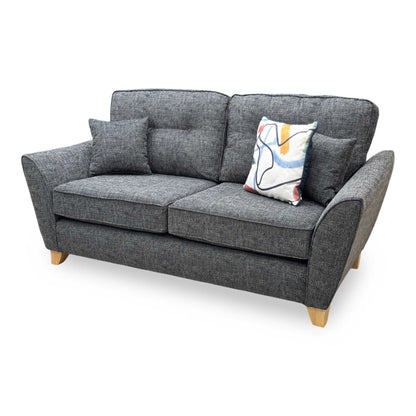 Side profile of the ‘Halstow’ sofa, highlighting the ergonomic slant of the backrest, clean neat tailored edges, and minimalist, angled black metal leg structure.