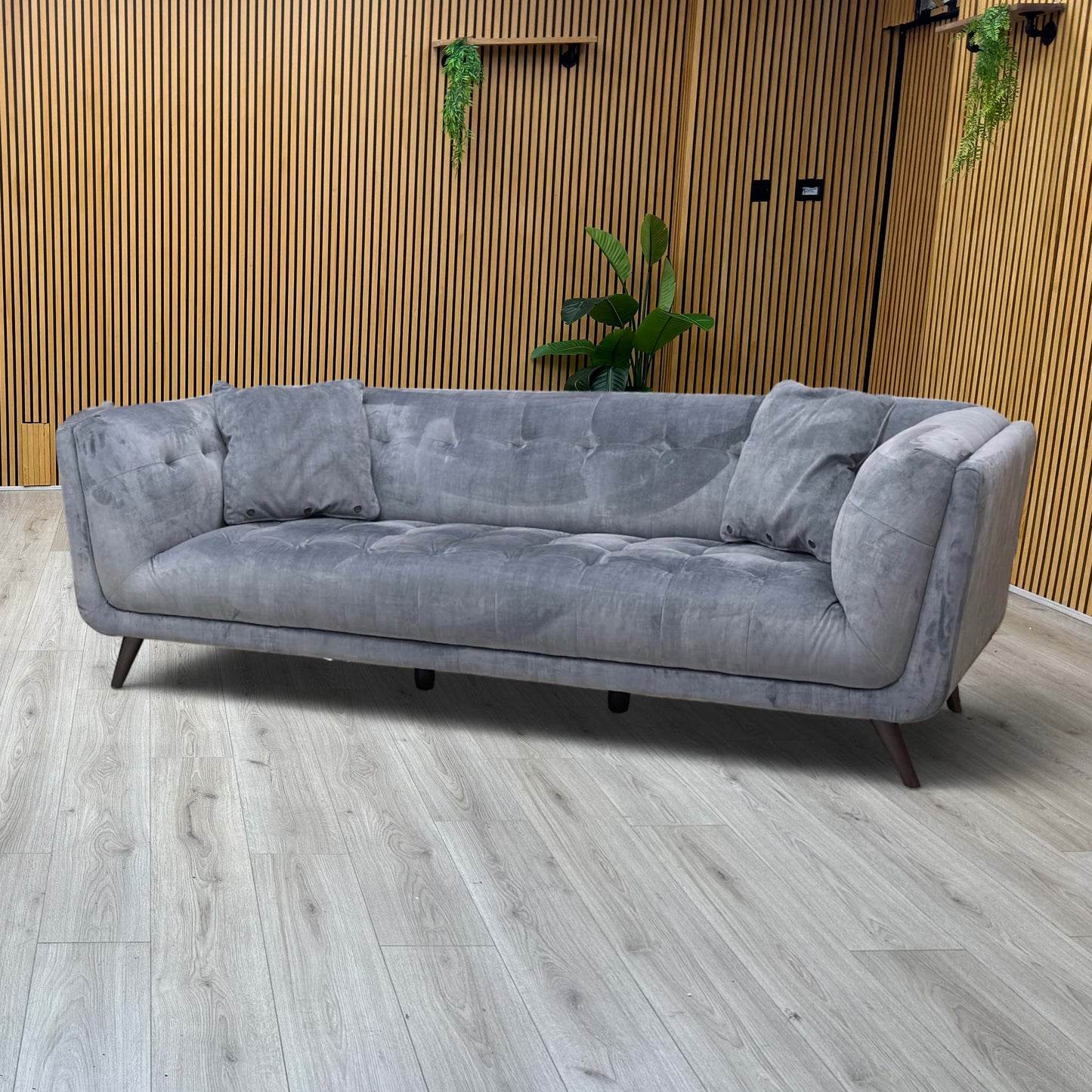 Lifestyle view of the ‘Rene’ 3-seater velvet sofa, emphasizing its generous depth, supportive low-profile arms, and inviting, cozy lounging aesthetic.