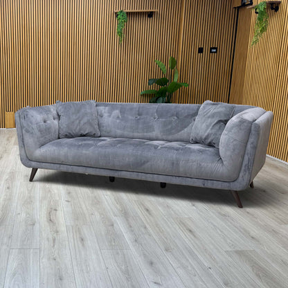 Lifestyle view of the ‘Rene’ 3-seater velvet sofa, emphasizing its generous depth, supportive low-profile arms, and inviting, cozy lounging aesthetic.