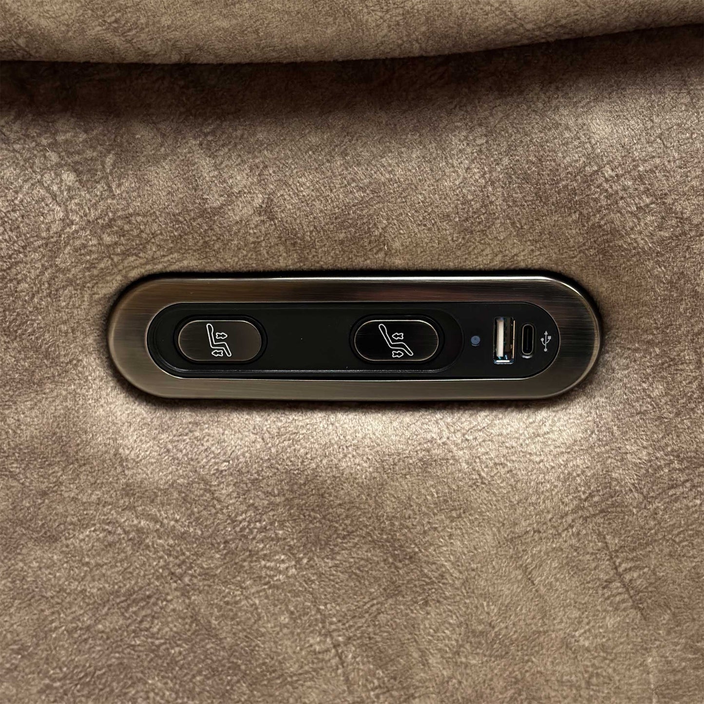 Detail shot of the sleek metallic power control panel on the outer armrest, highlighting the smooth transition buttons and the integrated USB port for device charging.
