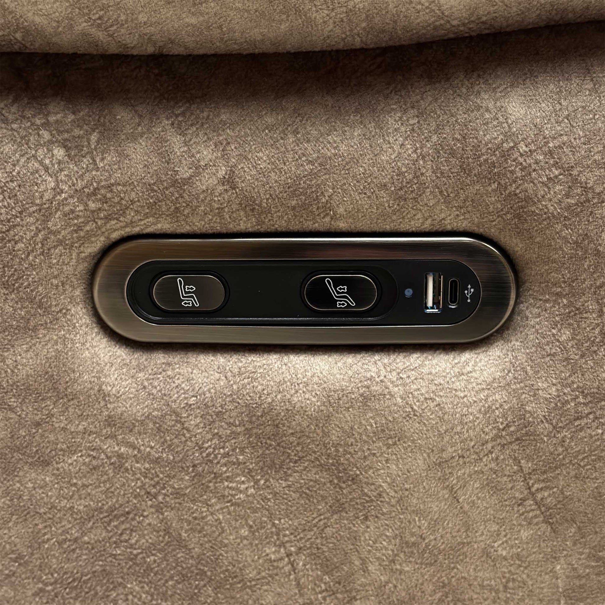 Detail shot of the sleek metallic power control panel on the outer armrest, highlighting the smooth transition buttons and the integrated USB port for device charging.