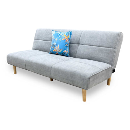 Side profile of the ‘Miyagi’ fabric futon, highlighting its neat armless silhouette and perfectly angled backrest designed for compact living spaces.