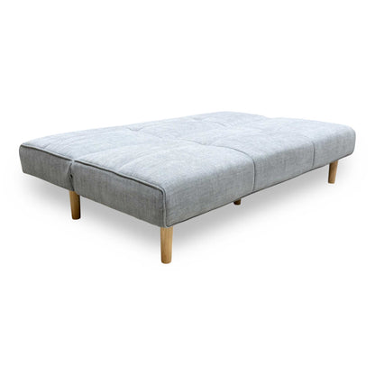 Side profile of the ‘Miyagi’ fabric futon, highlighting its neat armless silhouette and perfectly angled backrest designed for compact living spaces.