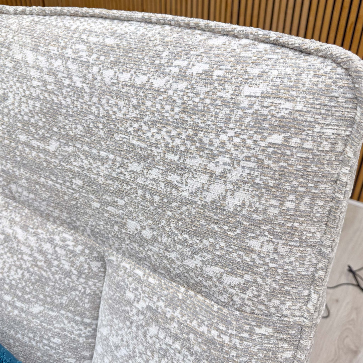 Close-up shot of the Maddox Smoke fabric upholstery on the ‘Maribo’ chair, showcasing the premium textured weave and sophisticated, neutral grey coloration.