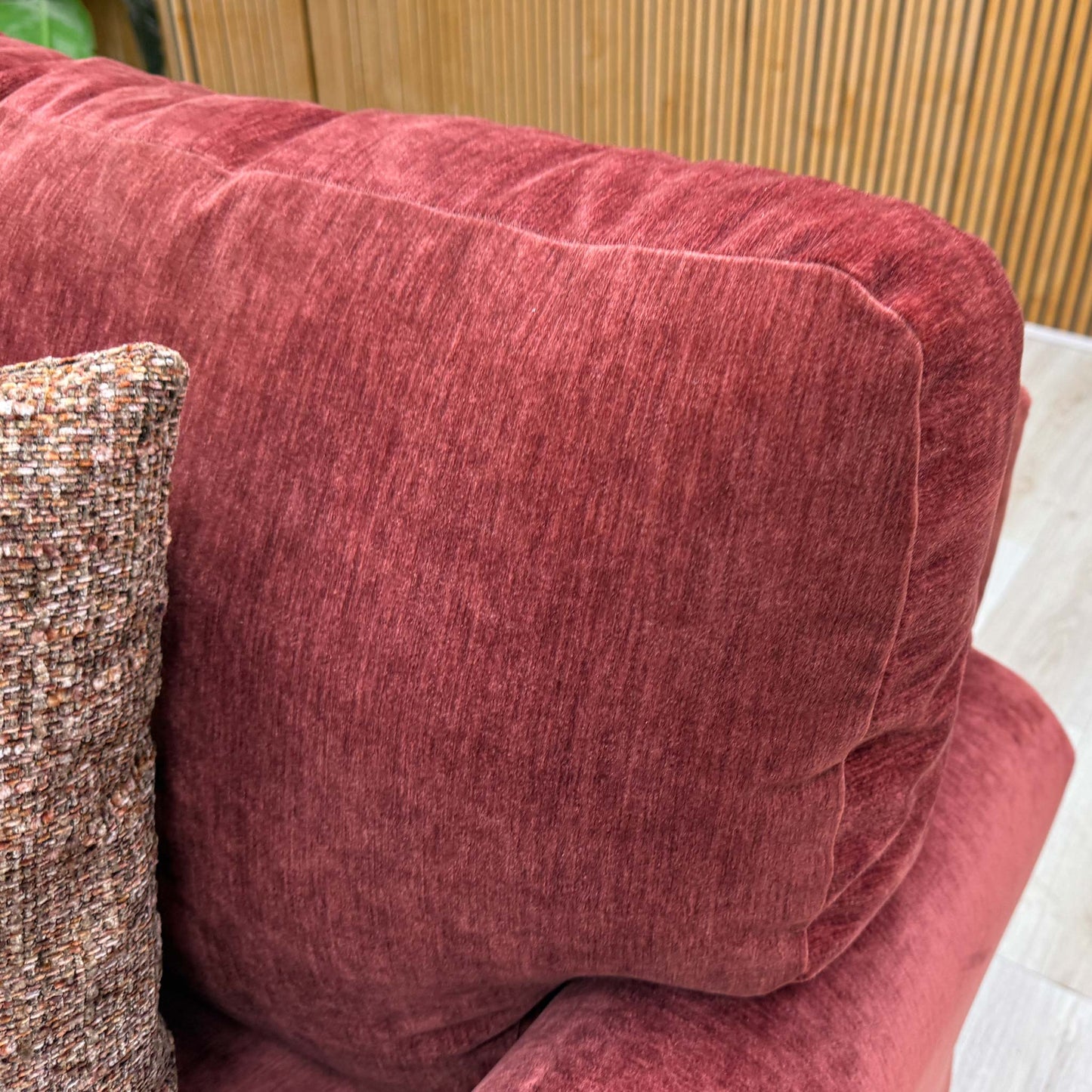 Close-up shot of the Paprika Red fabric on the ‘Jackson’ chair, showcasing the premium textured weave and vibrant, spicy red coloration.