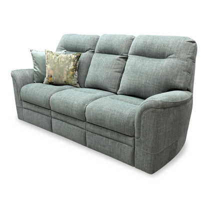 Side profile of the ‘Hudson 23’ fabric sofa, highlighting the sweeping lines of its padded arms, substantial lumbar support structure, and neat glide feet.