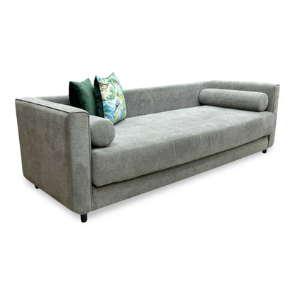 Side profile of the ‘Esprit’ day bed, emphasizing its slim, space-saving track arm design and neat, tailored silhouette.