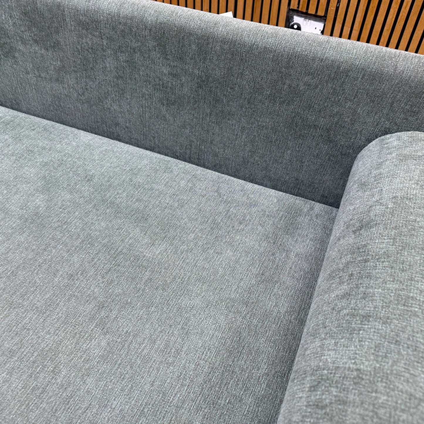 Close-up shot of the grey fabric upholstery on the ‘Esprit’ day bed, highlighting the highly resilient, modern textured weave and neutral charcoal-grey color tone.