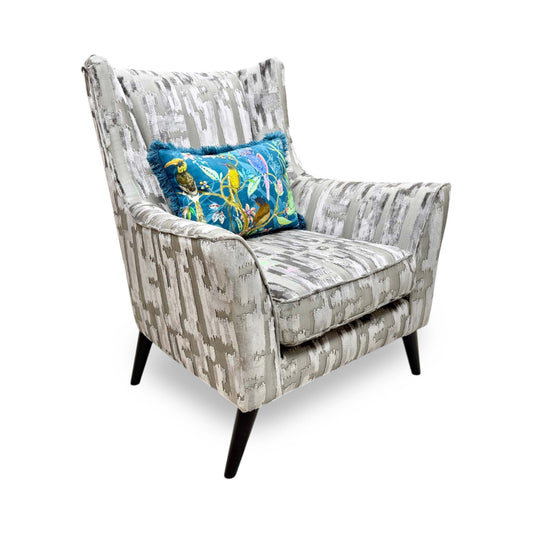 Full view of the Furniture Village Boutique ‘Allure’ Wing Chair in Iron patterned fabric, showcasing its high, supportive winged silhouette, gently curved arms, and elegant modern styling.