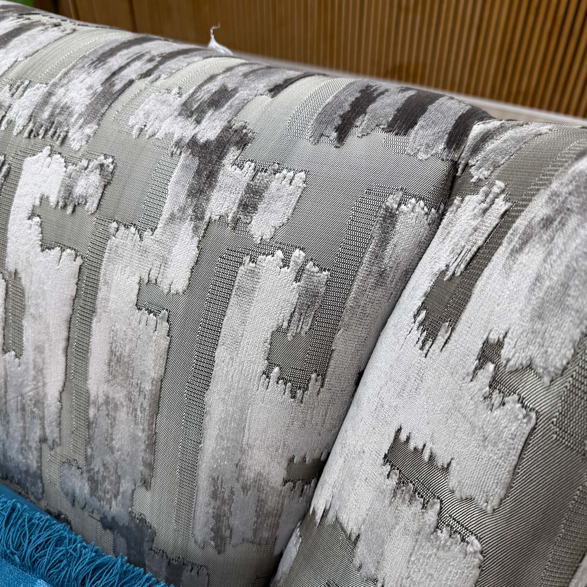 Close-up shot of the Iron patterned fabric upholstery on the ‘Allure’ chair, showcasing the sophisticated, multi-tonal abstract pattern and rich fabric weave.