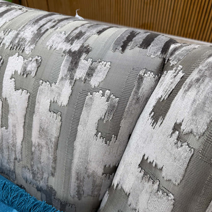 Close-up shot of the Iron patterned fabric upholstery on the ‘Allure’ chair, showcasing the sophisticated, multi-tonal abstract pattern and rich fabric weave.