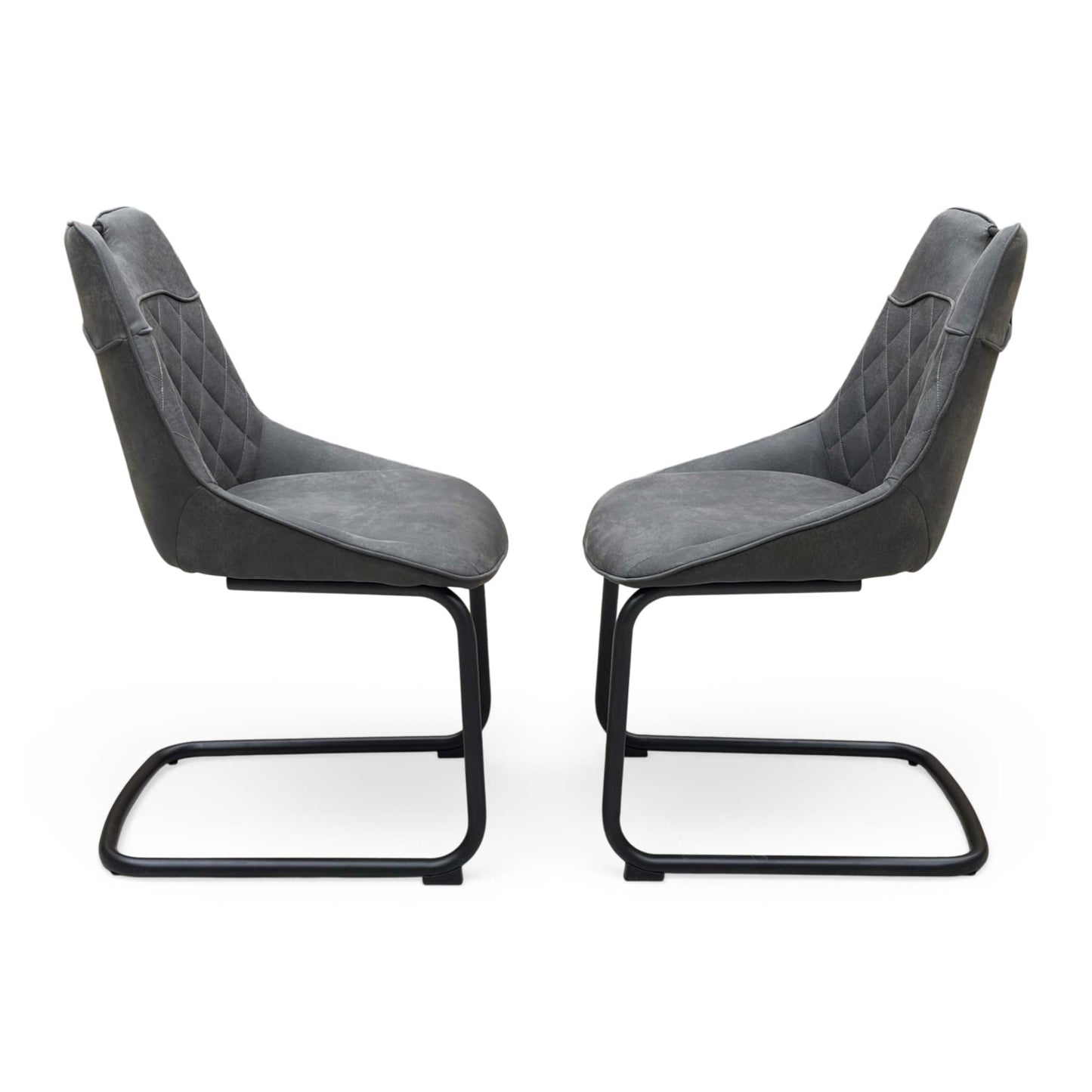 Front view of a pair of ‘Warrior’ Cantilever Dining Chairs in Charcoal Grey fabric, showcasing their sleek contemporary C-shaped frames, vertical channel-stitched backs, and minimalist industrial profile.