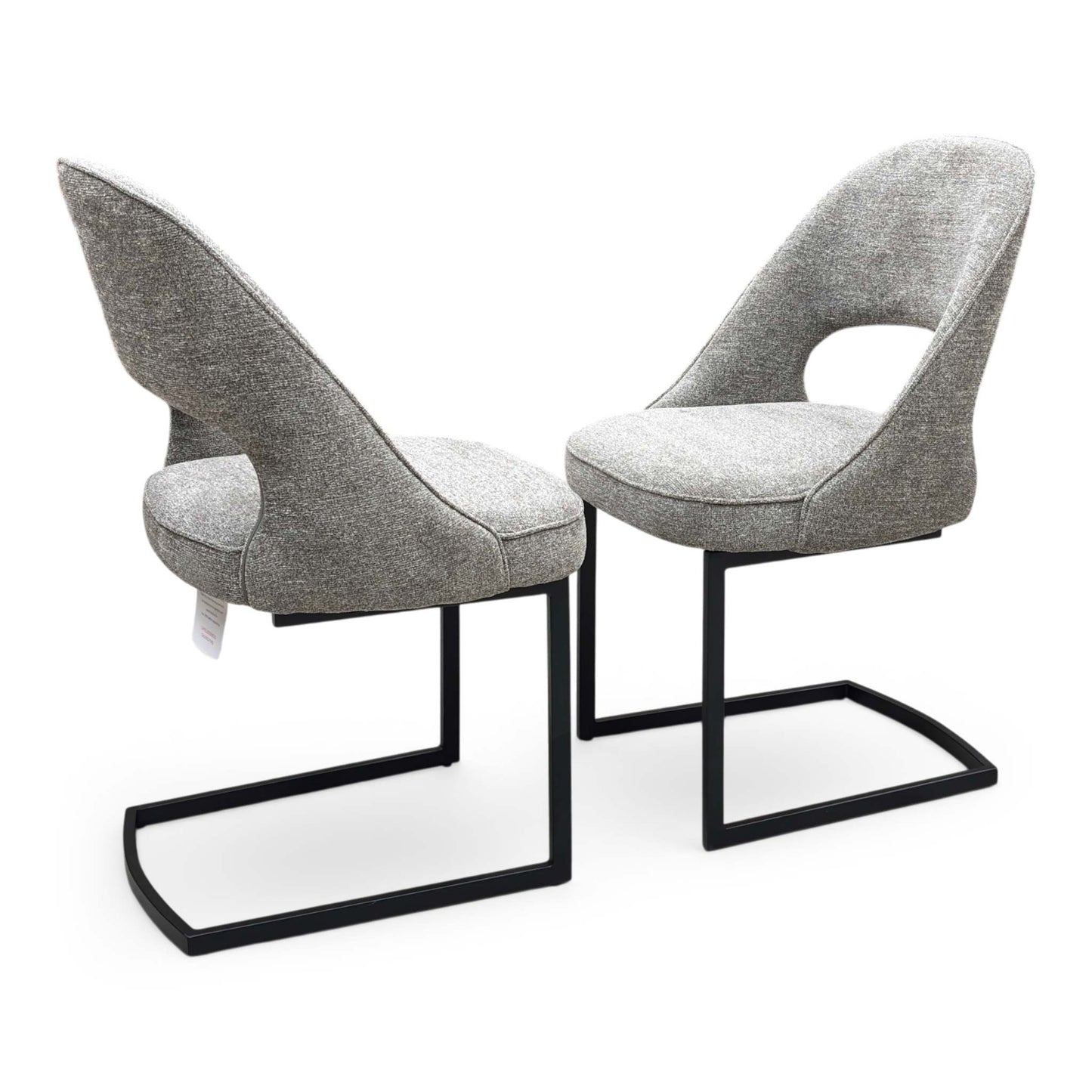 Full view of a pair of ‘Tiber’ Cantilever Dining Chairs in Truffle Brown fabric, showcasing their sleek contemporary C-shaped frames, vertical channel-stitched backs, and minimalist industrial profile.