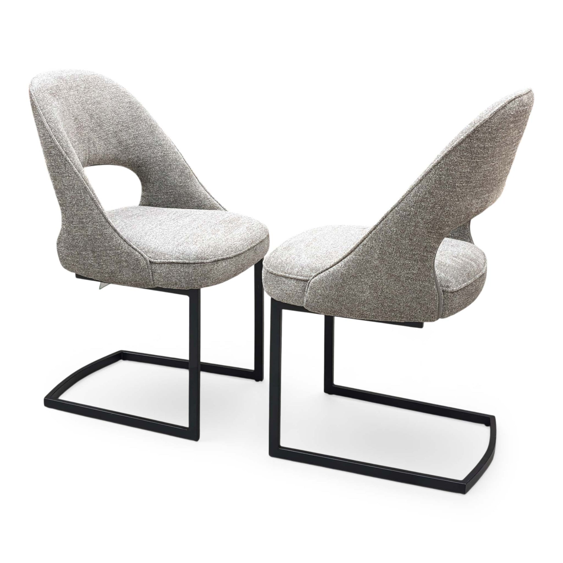 Side profile of the ‘Tiber’ dining chair, highlighting the clean, continuous curve of the matte black powder-coated cantilever base and the ergonomic slant of the backrest.