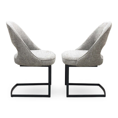 Front view of a pair of ‘Tiber’ Cantilever Dining Chairs in Truffle Brown fabric, showcasing their sleek contemporary C-shaped frames, vertical channel-stitched backs, and minimalist industrial profile.