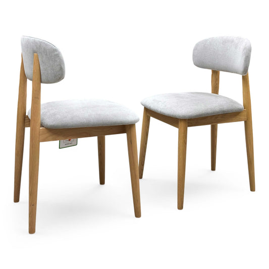 Full view for the ‘Stockholm’ light oak wooden dining chairs, highlighting the pair configuration, premium solid wood construction, and timeless Nordic style.
