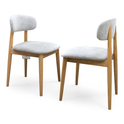 Side profile of the ‘Stockholm’ dining chair, highlighting its ergonomic gently curved back slats and elegantly tapered legs that create a light, airy silhouette.