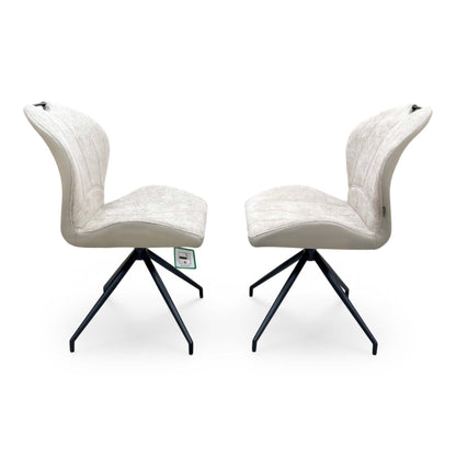 Side profile view of the Raul pebble taupe dining chair, illustrating the supportive seat scoop, padded cushion thickness, and modern leg angles.