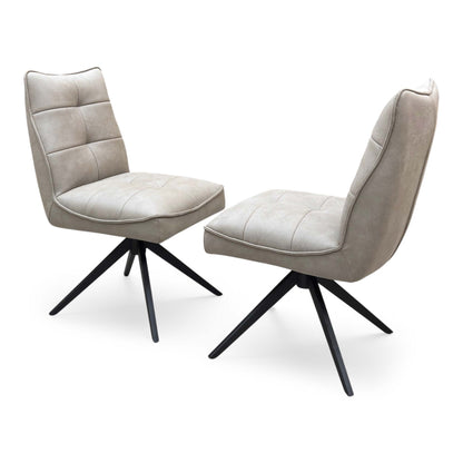 Side profile of the ‘Germain’ dining chair, highlighting its ergonomic gently curved backrest, supportive low-profile sides, and clean, angled black metal leg structure.