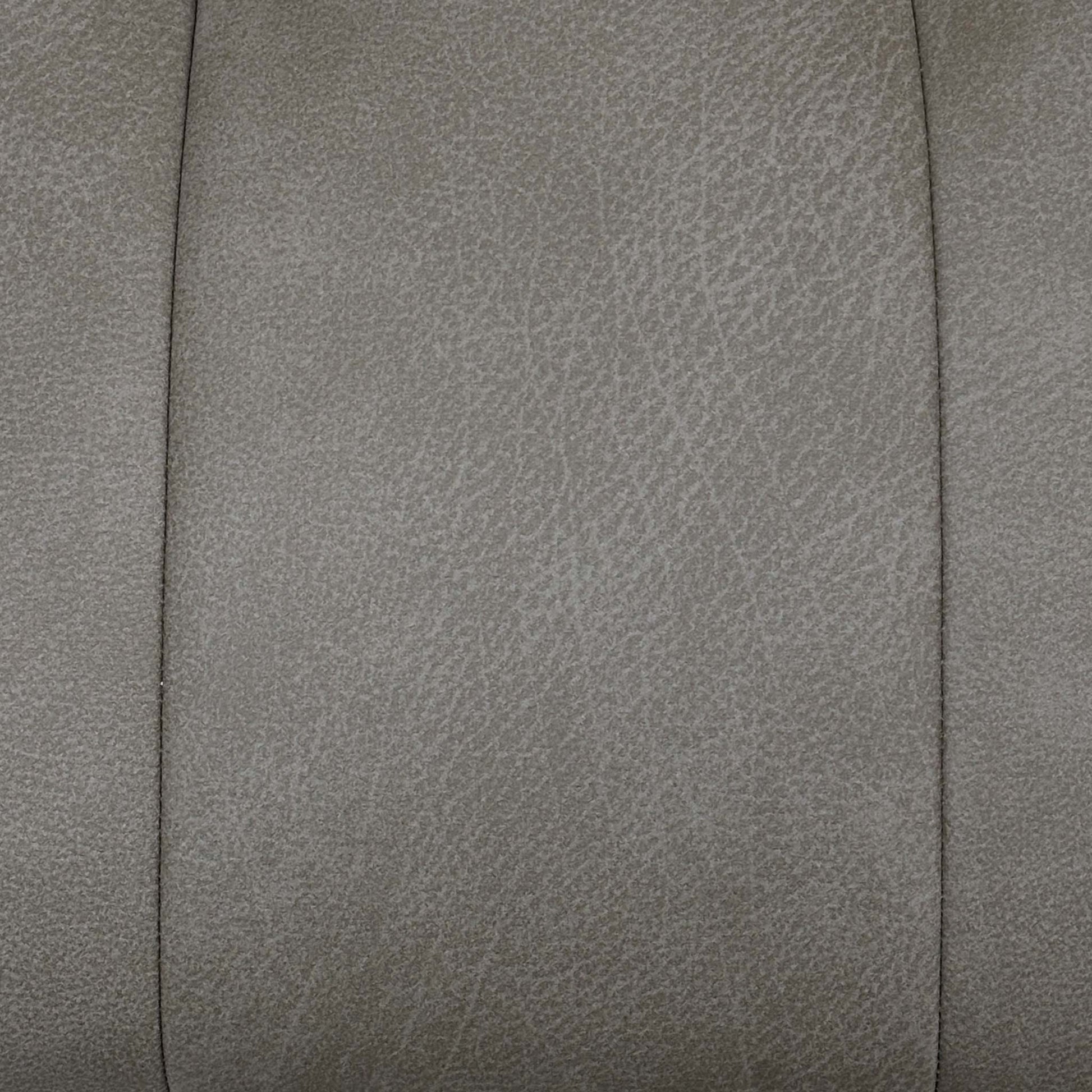 Close up shot for the ‘Germain’ Taupe faux leather dining chairs, highlighting the pair configuration, smooth 180-degree swivel return function, and modern industrial style.