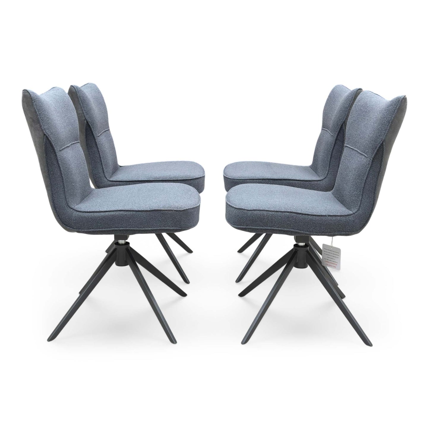 Front view of a set of 4 ‘Carrera’ Swivel Dining Chairs in Grey fabric, showcasing their contemporary diamond-stitched bucket seats, supportive wrap-around silhouettes, and sleek black metal spider legs.