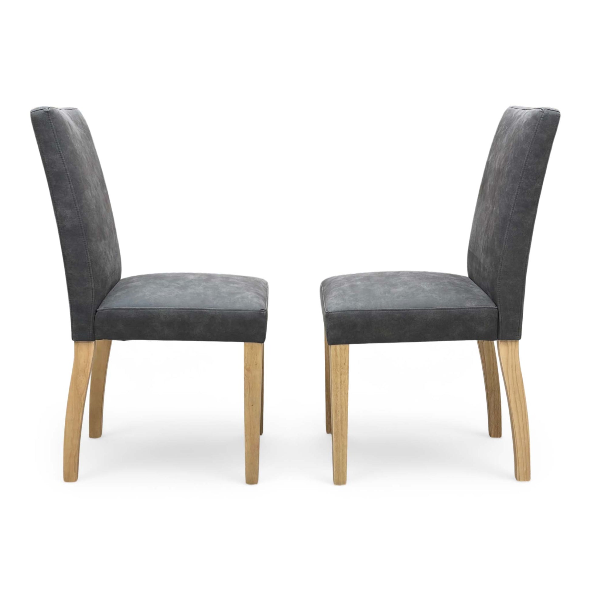 Side profile of the ‘Augusta’ upholstered chair, highlighting its ergonomic gently curved backrest and clean, angled black powder-coated metal leg design.