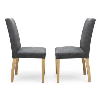 Side profile of the ‘Augusta’ upholstered chair, highlighting its ergonomic gently curved backrest and clean, angled black powder-coated metal leg design.