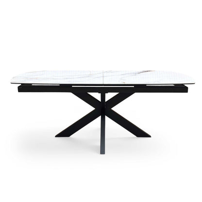 Front view of the Furniture Village ‘Raul’ Pop-Up Extending Dining Table, showcasing its luxurious Fiorentino white marble-effect ceramic top and striking black star-burst metal legs.