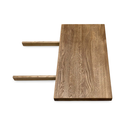 Side view of the Earth solid oak dining table extension leaf, illustrating the heavy-duty metal insertion prongs and secure mounting hardware.