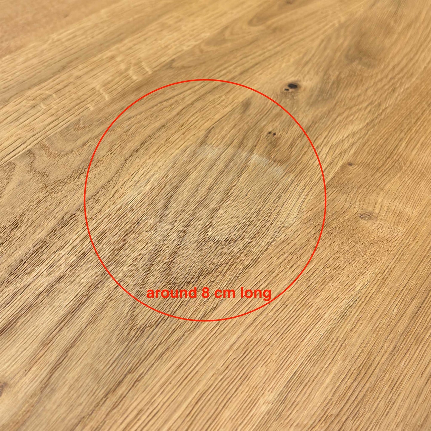 Close-up shot of the solid natural oak table top on the ‘Earth’ dining table, showcasing the rich wire-brushed texture, distinctive natural character markings, and oiled finish.