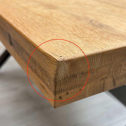 Close-up shot of the solid natural oak table top on the ‘Earth’ dining table, showcasing the rich wire-brushed texture, distinctive natural character markings, and oiled finish.