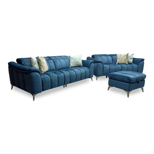 Full view of the Angelo Giula dark blue fabric 3 and 2-seater sofa set with matching storage footstool, showcasing the modern low profile and fluted back upholstery.