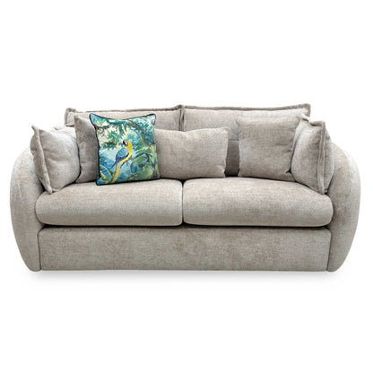 Front view of the three-seater sofa upholstered in a neutral stone-colored wicker-textured fabric, featuring plush scatter back cushions and a deep, structured seat design.
