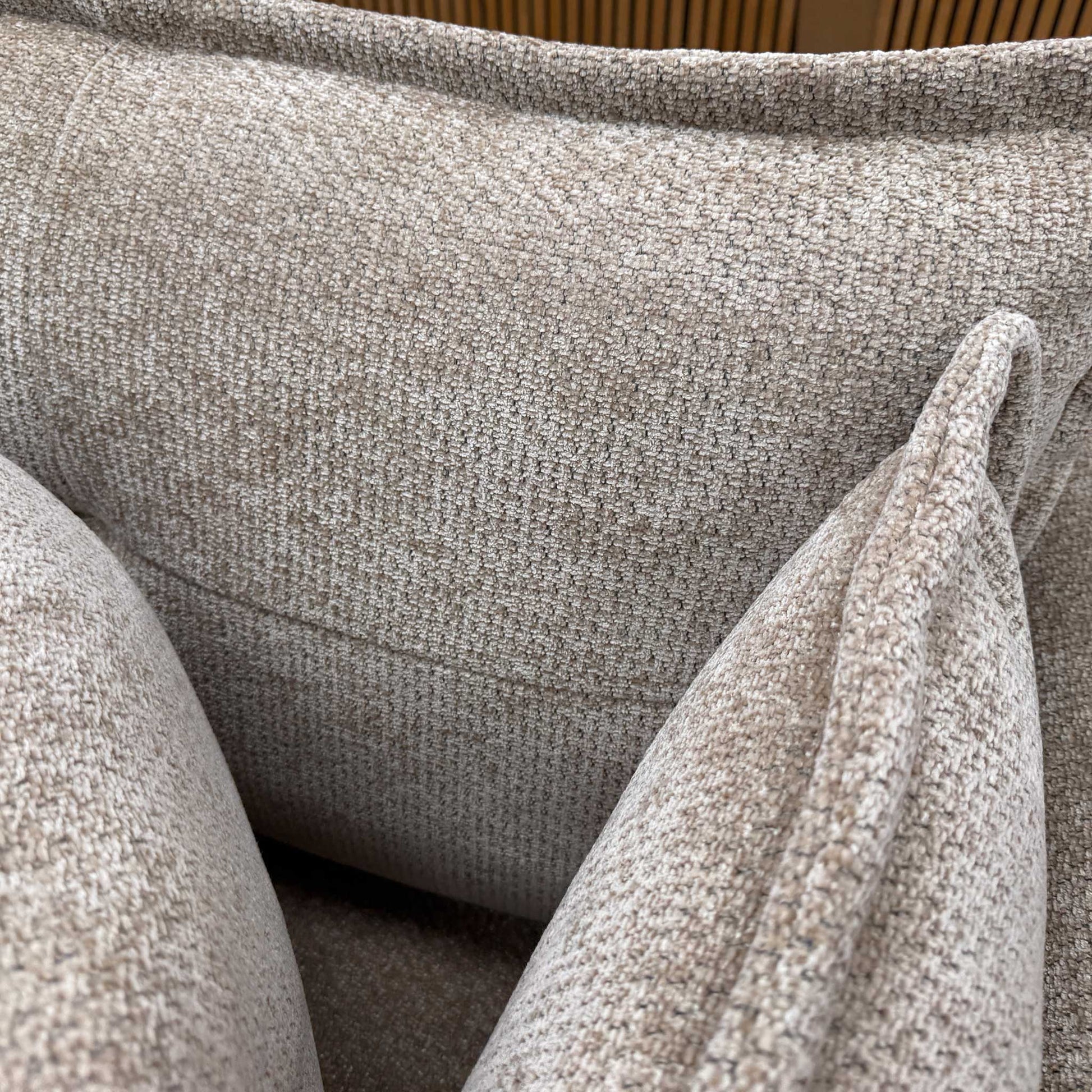 Close-up detail of the Portobello sofa upholstery, showing the high-quality weave texture of the stone-colored wicker fabric and durable tailored piping lines.