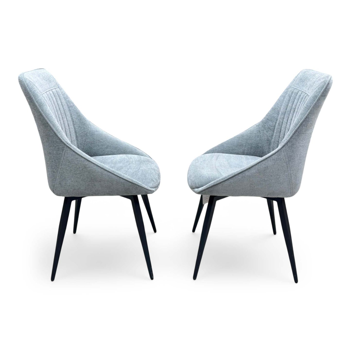 Side profile of the Crete swivel chair, emphasizing the elegant wrap-around curvature of the backrest and the clean, minimalist lines of the frame.