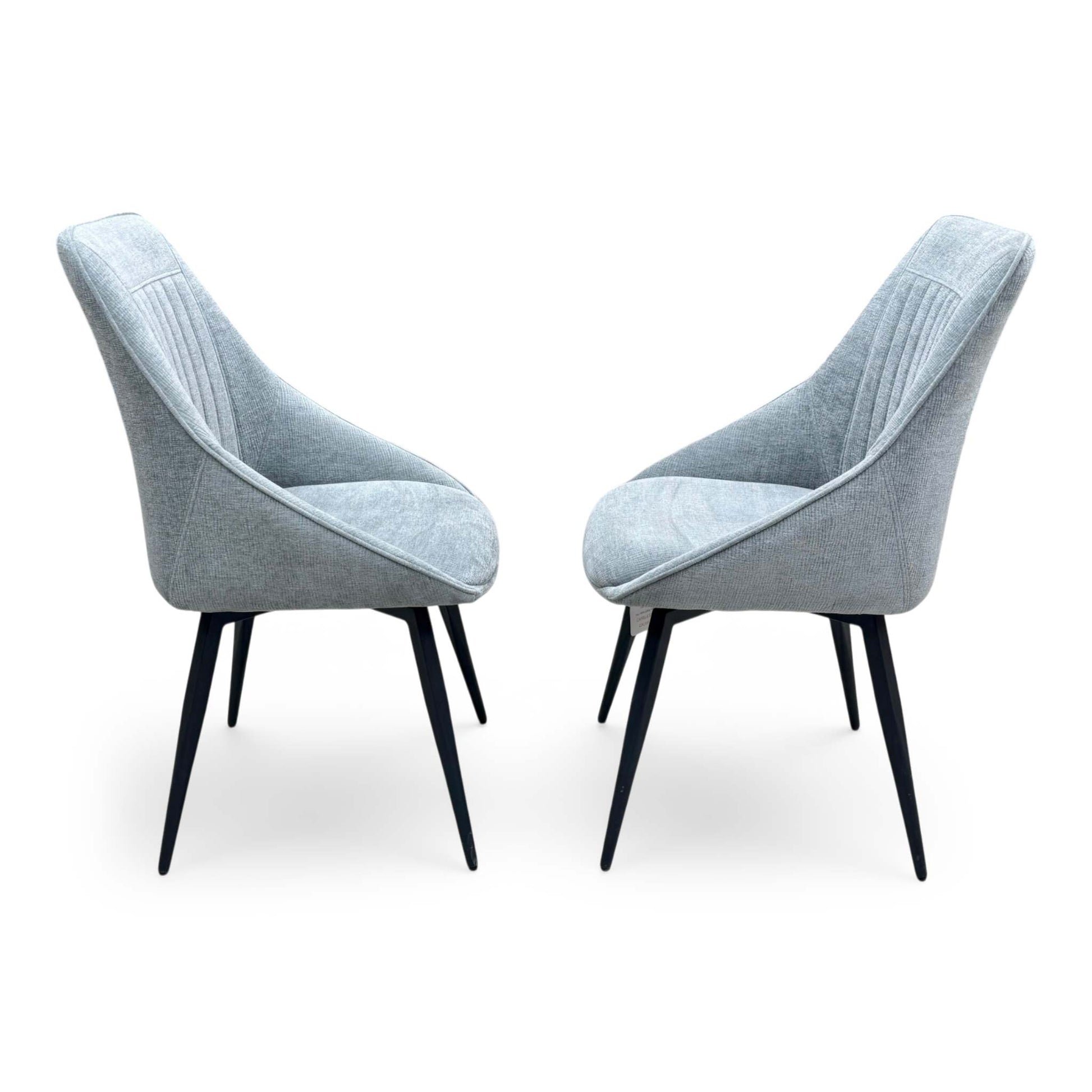 Side profile of the Crete swivel chair, emphasizing the elegant wrap-around curvature of the backrest and the clean, minimalist lines of the frame.