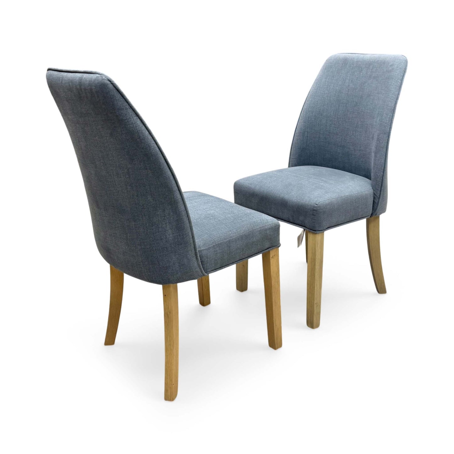 Full view of a pair of Furnitureland 'Hamilton' dining chairs in charcoal grey fabric, highlighting the elegant high roll-back profile and sophisticated button-back detailing.