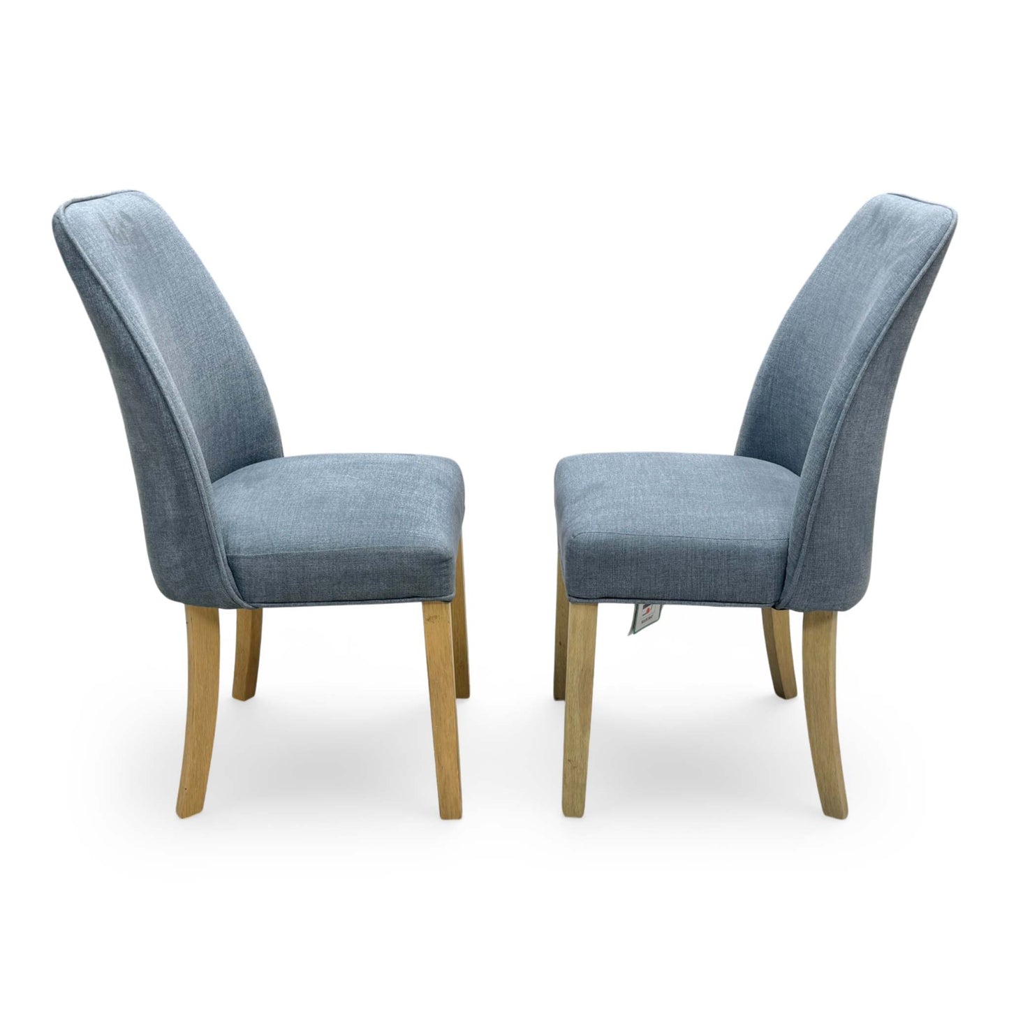 Side profile of the Hamilton dining chair, showing the elegant curvature of the backrest and the straight, supportive design of the solid wooden legs.