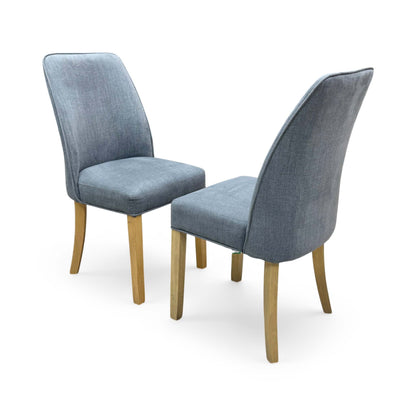 Side profile of the Hamilton dining chair, showing the elegant curvature of the backrest and the straight, supportive design of the solid wooden legs.