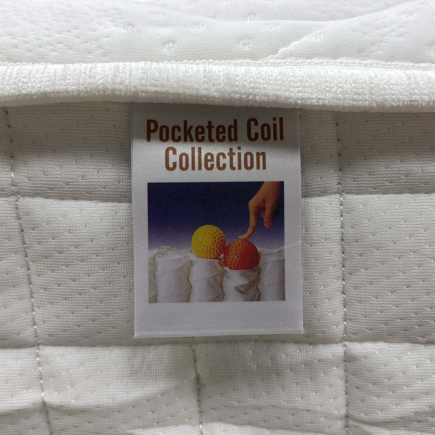 Macro view of the Comfort Pocket 1000 mattress surface, emphasizing the soft-touch knitted fabric weave, breathable stitching patterns, and premium tufted finish.