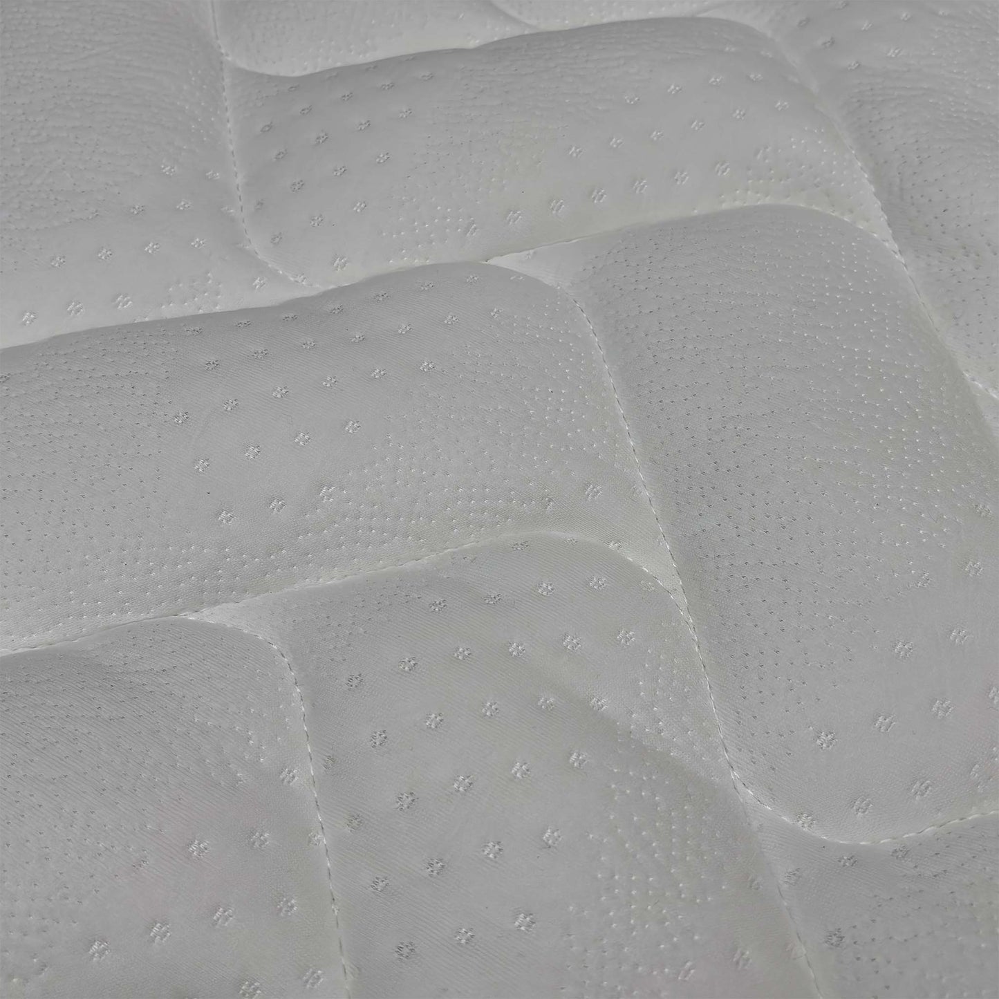 Macro view of the Comfort Pocket 1000 mattress surface, emphasizing the soft-touch knitted fabric weave, breathable stitching patterns, and premium tufted finish.