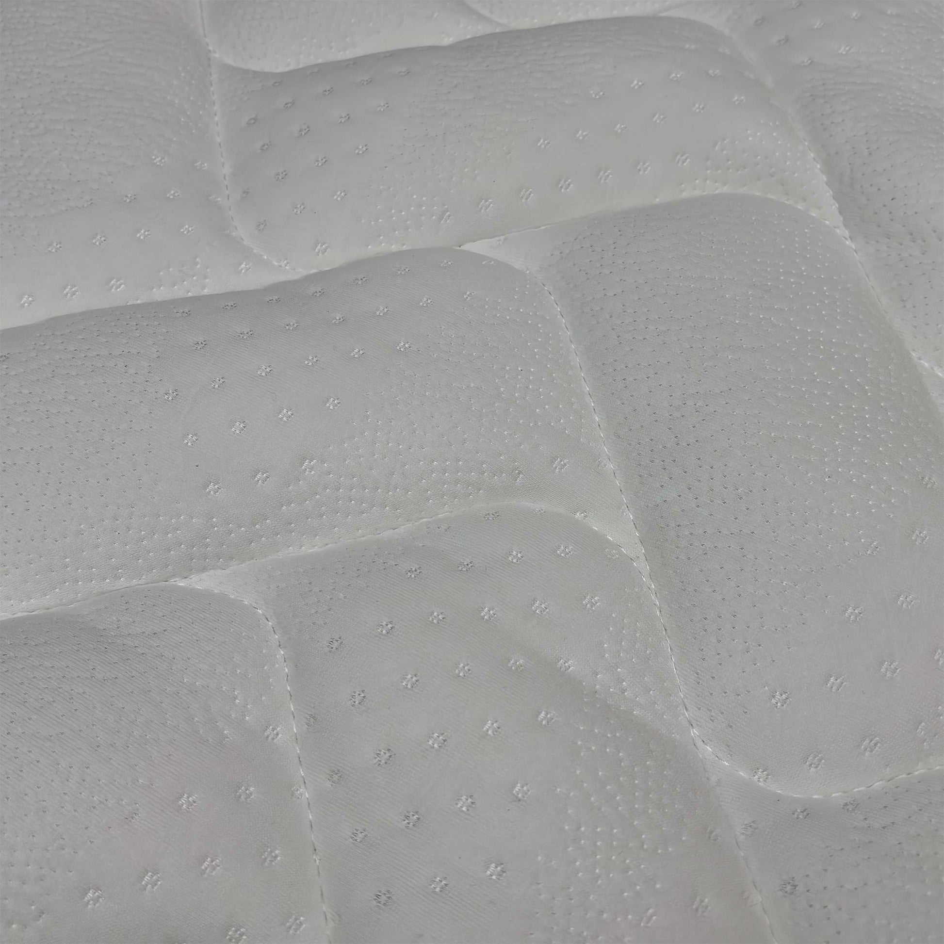 Macro view of the Comfort Pocket 1000 mattress surface, emphasizing the soft-touch knitted fabric weave, breathable stitching patterns, and premium tufted finish.