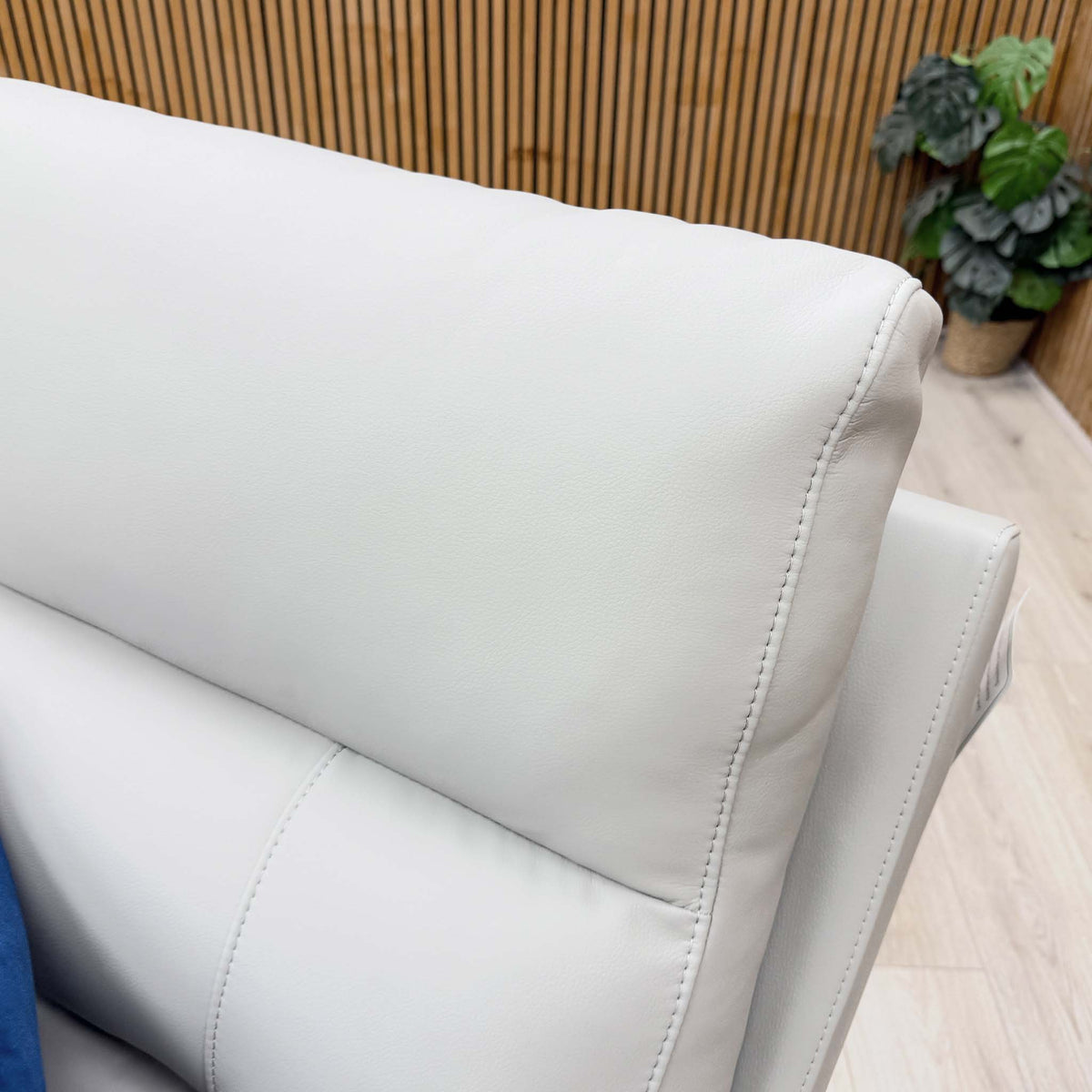 Close-up of the stitched light grey leather back cushion on the Sally sofa