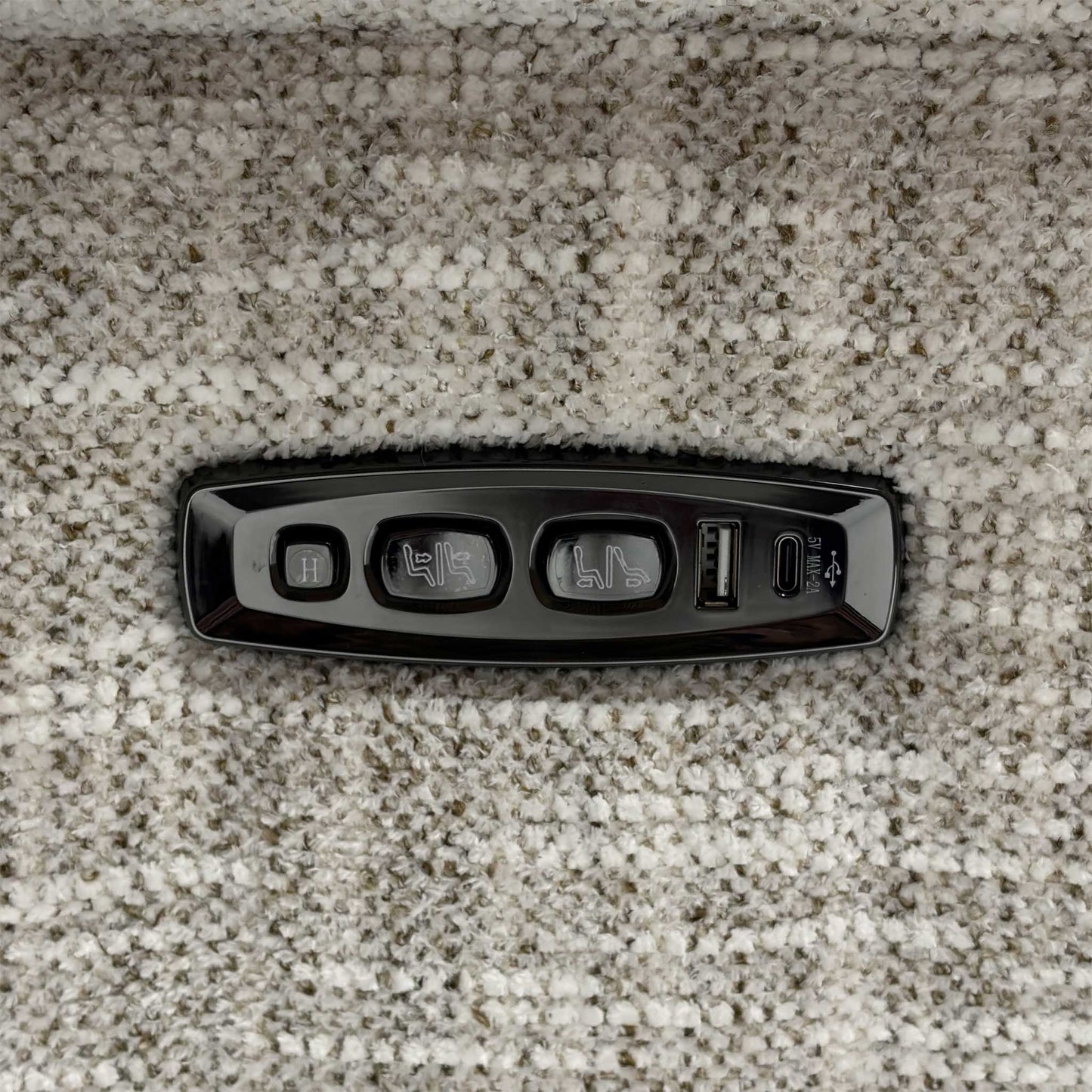 Close up view of the Nova MGA-R04 beige fabric upholstery, emphasizing the high-quality woven texture, durable seams, and integrated power recliner control switches.