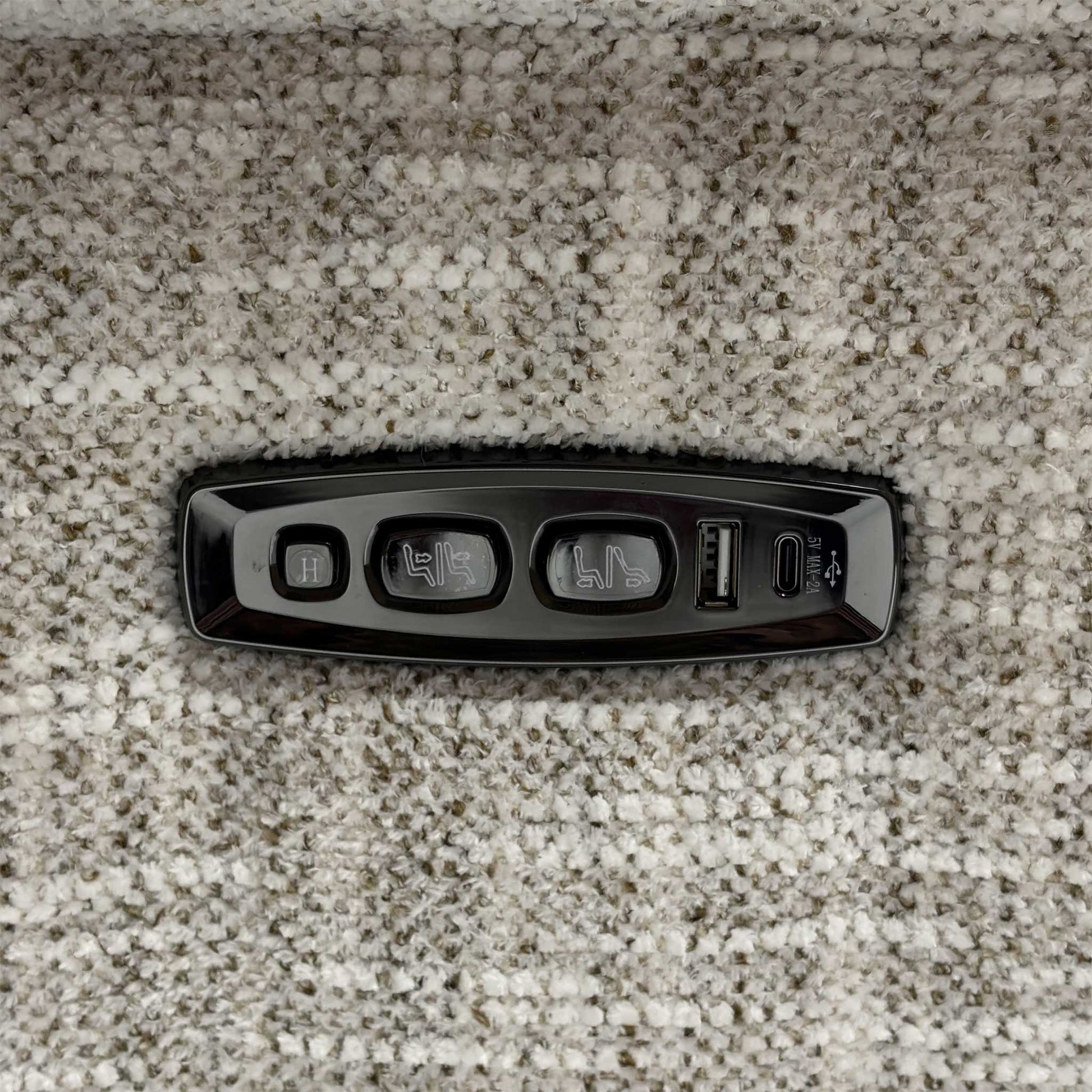 Close up view of the Nova MGA-R04 beige fabric upholstery, emphasizing the high-quality woven texture, durable seams, and integrated power recliner control switches.