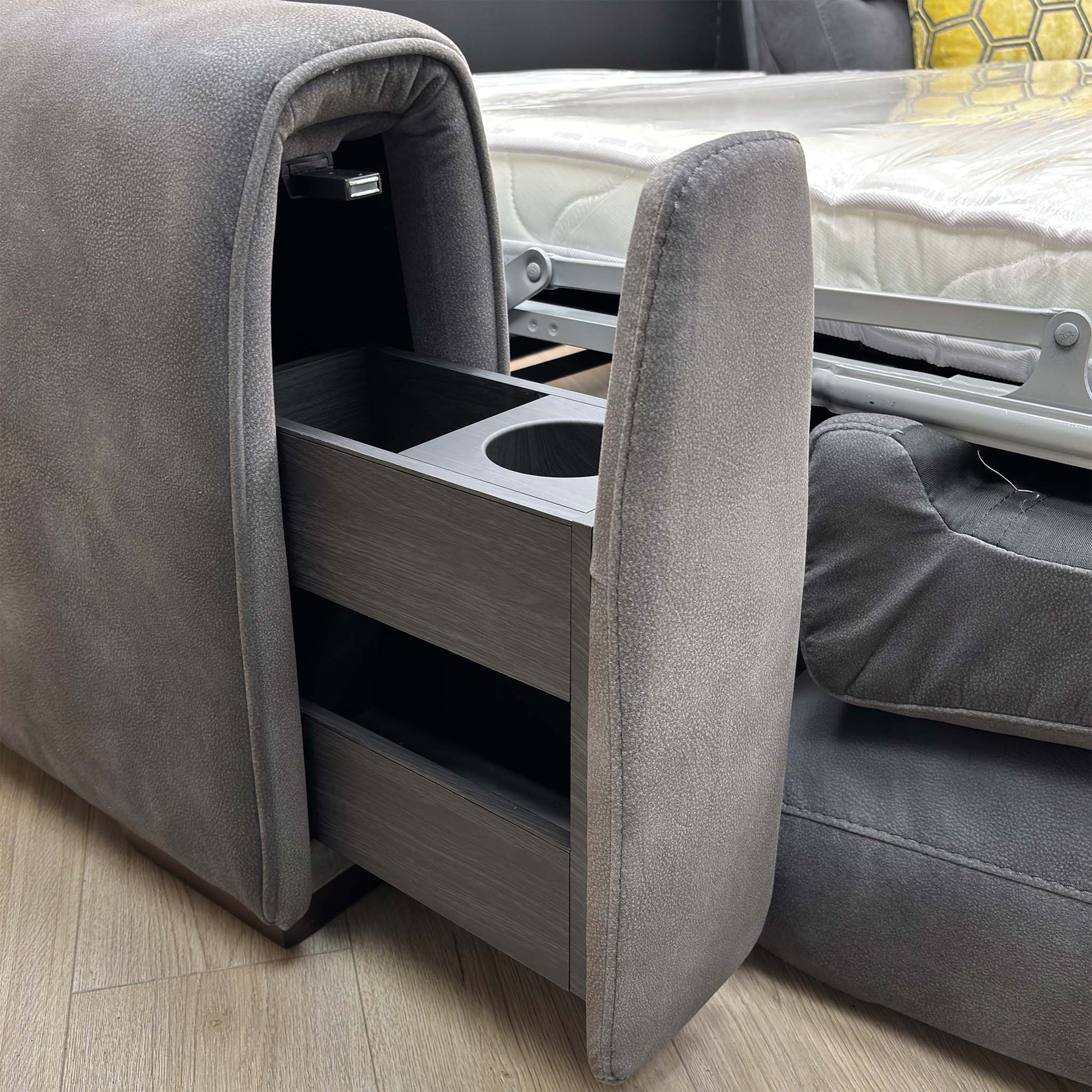 Close up view of the Flex graphite grey fabric corner sofa bed, showcasing clean, fully upholstered back panels suitable for placement in open-plan rooms.