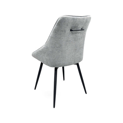 Crete silver fabric swivel dining chair from the rear right with tapered black metal legs