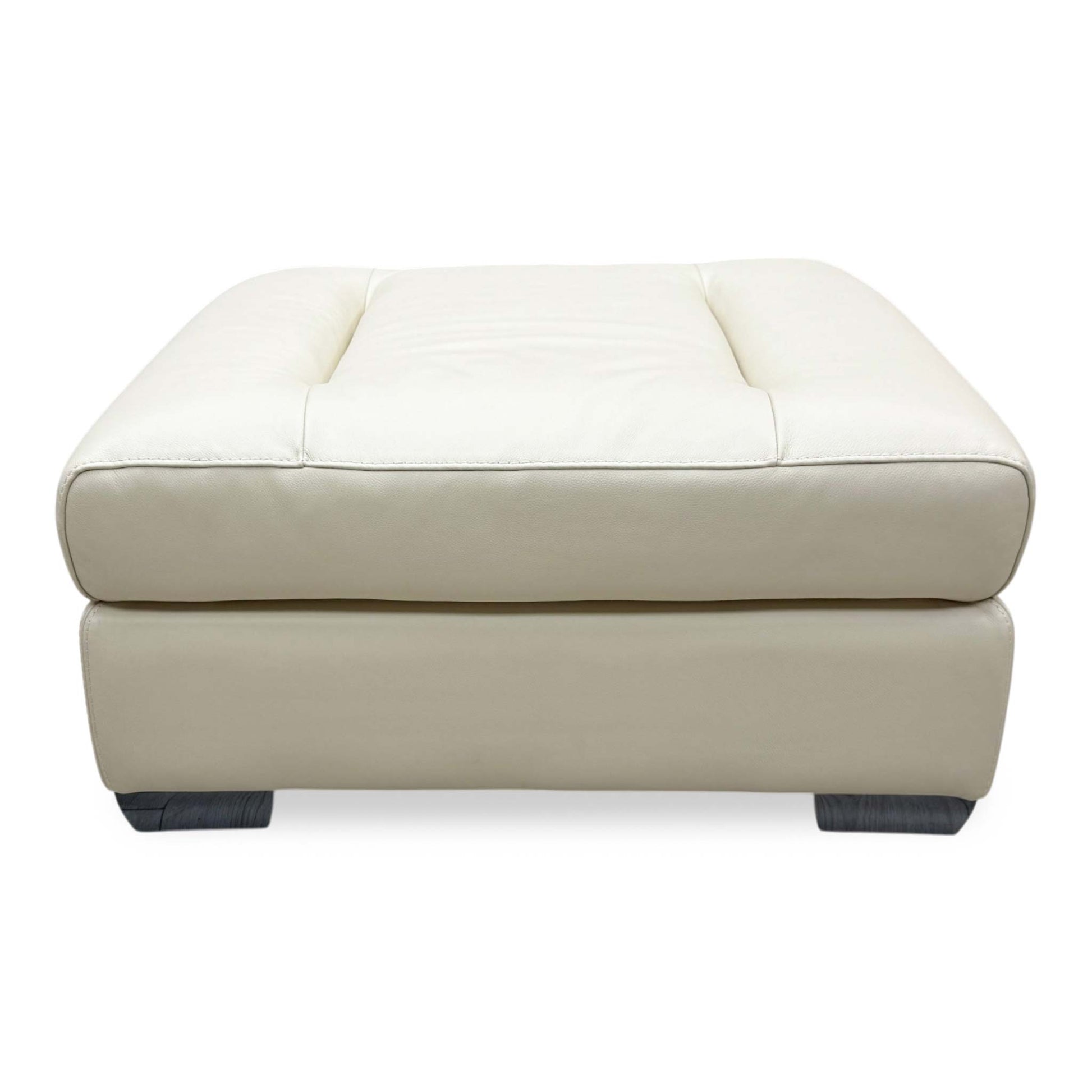 Front-facing view of the Action Taupe leather footstool, highlighting the perfectly flat, uniform surface cushion and crisp, symmetrical tailored perimeter.
